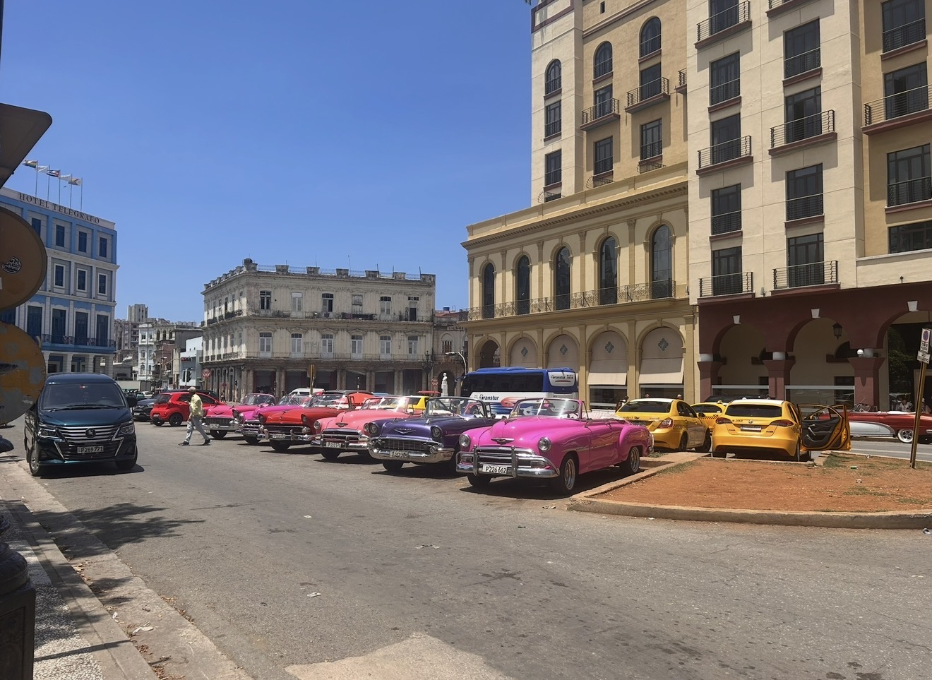 Row of colourful vintage cars parked on a street in Havana, Cuba