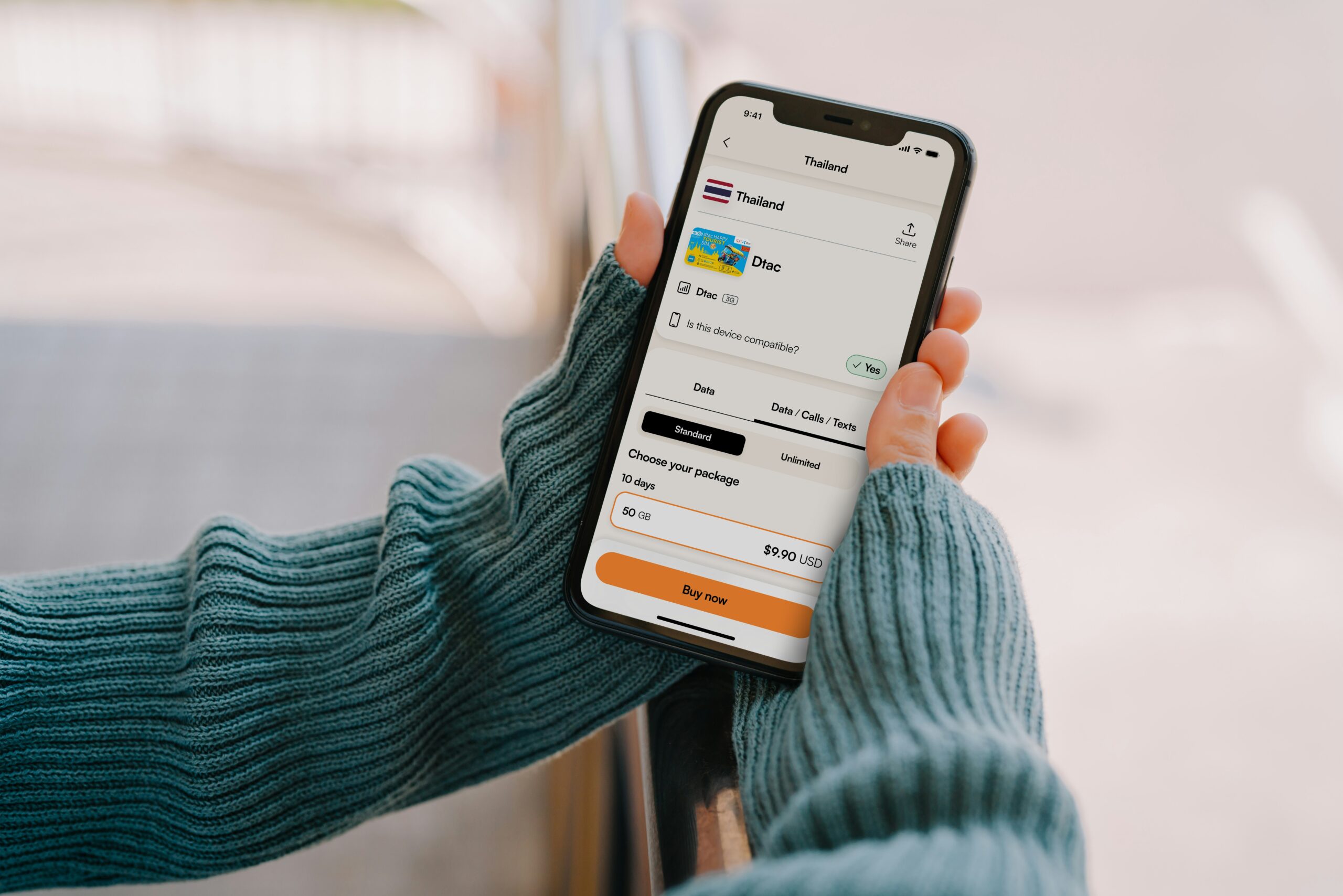 Hand holding a phone showing an eSIM data plan purchase screen